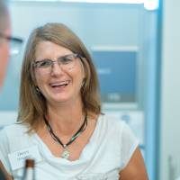 Guests chatting with drinks at the Engineering Design Project Preview
